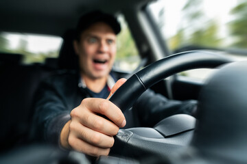Bad driver in car. Shocked angry man yelling while driving. Road rage. Braking in fast high speed...
