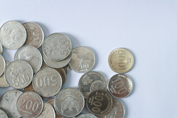 Indonesian Rupiah coins on a white background, the official currency of Indonesia.