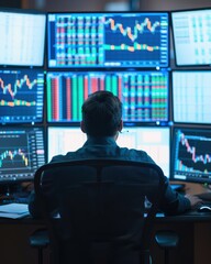 Fototapeta premium Professional trader analyzing data on multiple screens in a modern office, focused on market trends and stock performance.