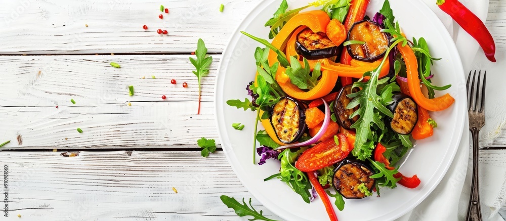 Poster top view of a healthy vegetable salad on a white plate with fried aubergines peppers and carrots set