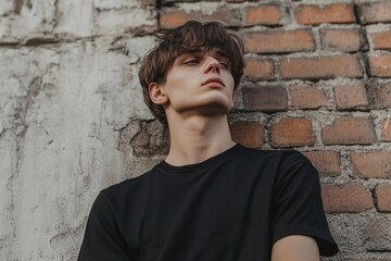 Fototapeta premium Man Leaning Against Brick Wall