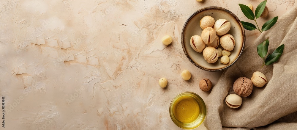 Poster flat lay of tasty organic macadamia nuts and cosmetic oil on a beige background with room for text b