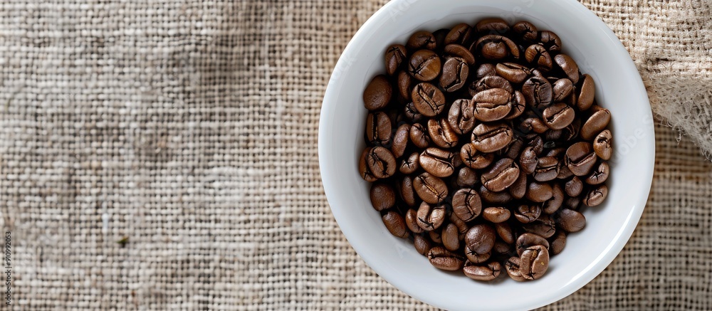 Poster a white cup with roasted coffee beans on sackcloth can serve as a copy space image backdrop