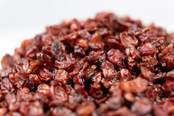 Red dried barberry on white background