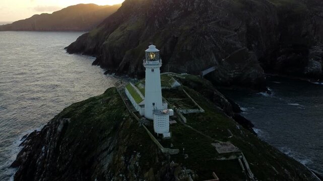 South Stack lighthouse aerial view circling island landmark revealing sunrise mountains