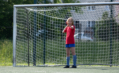 Girl Goalkeeper Stands At Goalposts During Children'S Football Match