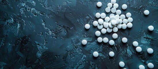 Tablets scattered on dark backdrop with copy space image.
