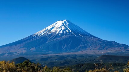 A snow capped mountain peak with a clear blue sky.