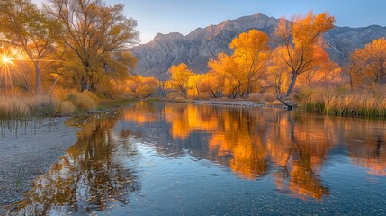 Obraz premium Serene autumn reflections by a tranquil river in the mountains at sunset