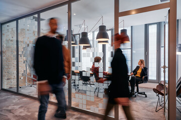In the dynamic hustle and bustle of a business environment, a group of young business professionals...