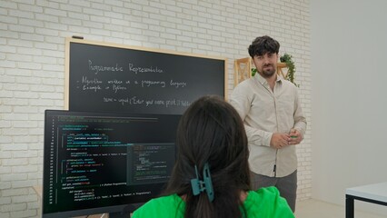 Engaged Computer Science Instructor Teaching in Modern Classroom