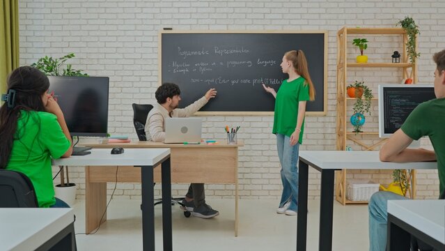 Student and Instructor Discuss Python Code in Modern Classroom