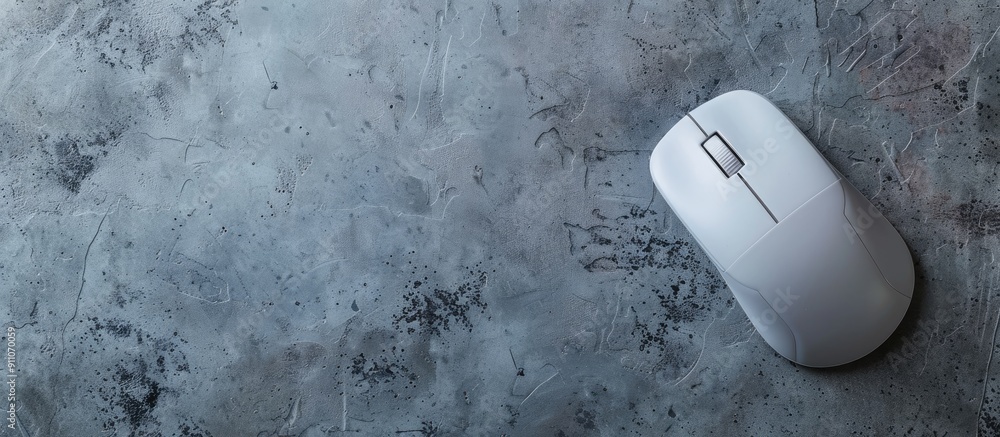 Poster an aerial view of a single wireless mouse with a mousepad on a gray backdrop providing ample copy sp