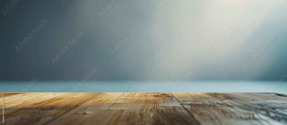 Poster wooden desk with no items on it set against a grey textile background creating a clean and minimalis