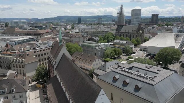 4K Drone Video of Trains, Churches and Historic Buildings of the Skyline of Basel, Switzerland (Pedestal Up)