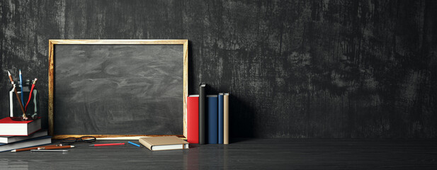 Creative educational supplies and empty blackboard on wide background with mock up place. Back to...