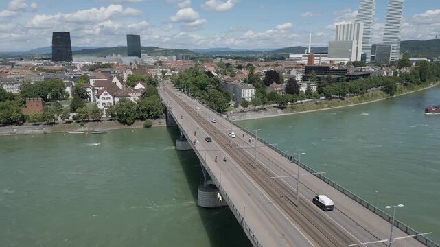 4K Drone Video of Wettsteinbr&uuml;cke Bridge over the Rhine River in Basel, Switzerland with Barges Approaching (Truck Right)