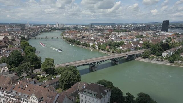 4K Drone Video of Tugboat Pulling Barge Towards the Wettsteinbr&uuml;cke Bridge over the Rhine River in Basel, Switzerland (Dolly Forward)