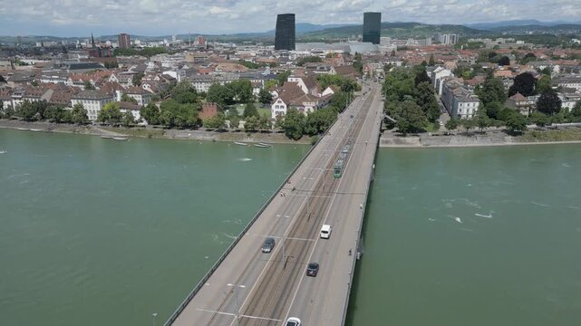 4K Drone Video of Train Crossing Wettsteinbr&uuml;cke Bridge over the Rhine River Towards Modern Skyscrapers in Basel, Switzerland (Pedestal Up)