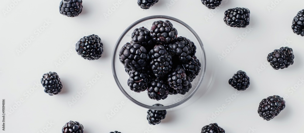 Aufkleber a white background with scattered blackberries in a glass providing space for text or images viewed 