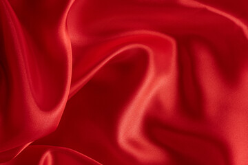 Background is smooth elegant texture of red silk or satin.