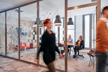 In the dynamic hustle and bustle of a business environment, a group of young business professionals...