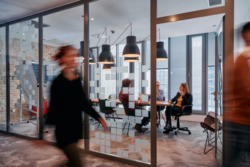 In the dynamic hustle and bustle of a business environment, a group of young business professionals...