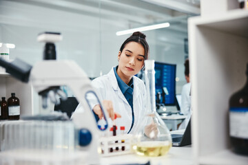Test tubes, woman and medical scientist in laboratory with blood samples for cancer clinical trial....