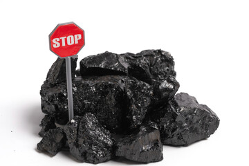 Obraz premium Pile of coal with stop sign isolated on a white background.