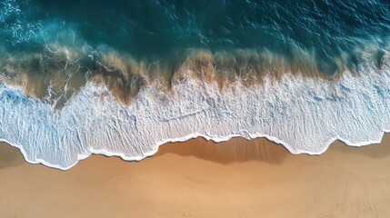 Top-down view of a beach with waves gently rolling onto the sand, taken from above
