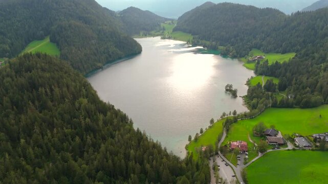 Hintersteiner See mountain lake in Austria near town of Kufstein, aerial view in summer at sunset in cloudy weather. Hintersteiner See in Oesterreich in der Nahe der Stadt Kufstein Luftaufnahme. 