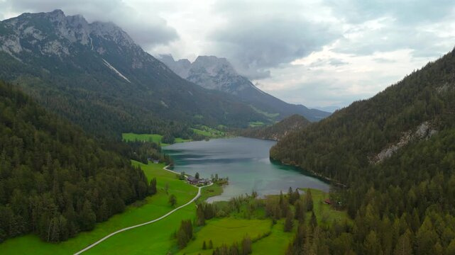 Hintersteiner See mountain lake in Austria near town of Kufstein, aerial view in summer at sunset in cloudy weather. Hintersteiner See in Oesterreich in der Nahe der Stadt Kufstein Luftaufnahme. 