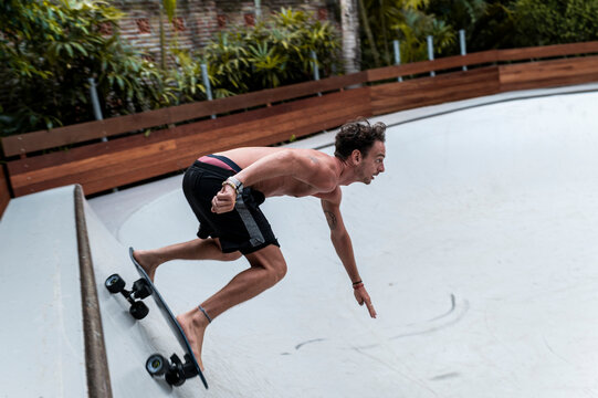 Barefoot skater leaning into sharp turn