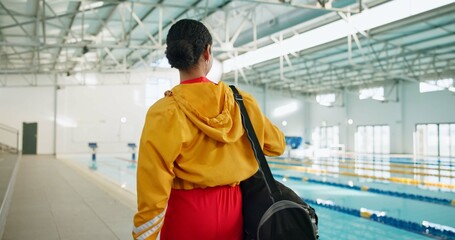 Swimming pool, back or woman at gym for fitness with bag for water sport, hydro exercise or walk. Swimmer, athlete or prepare for training, competition or wellness with practice gear for healthy body
