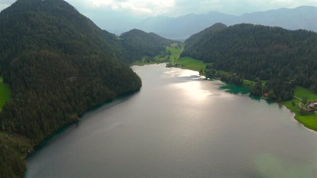 Hintersteiner See mountain lake in Austria near town of Kufstein, aerial view in summer at sunset in cloudy weather. Hintersteiner See in Oesterreich in der Nahe der Stadt Kufstein Luftaufnahme. 