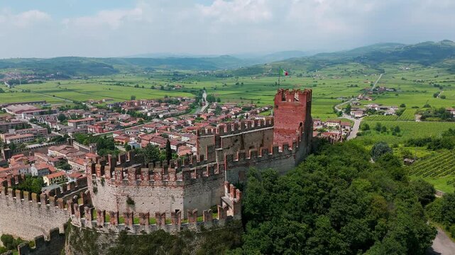 Aerial view of the medieval scaliger castle in soave, italy, showcasing its well preserved architecture and the surrounding vineyards