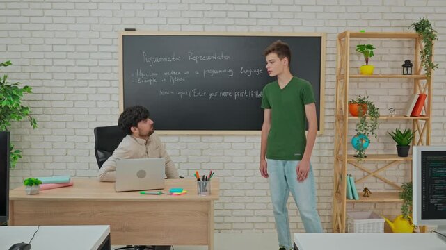 Student and Instructor Discuss Python Code in Modern Classroom