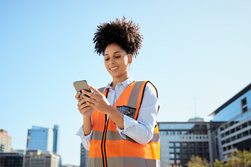 Confident Female Construction Worker Using Smartphone at Modern Urban Construction Site