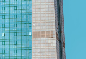many windows and walls facade of a modern skyscraper without people