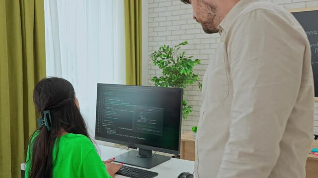 Instructor Providing One-on-One Coding Assistance in Classroom