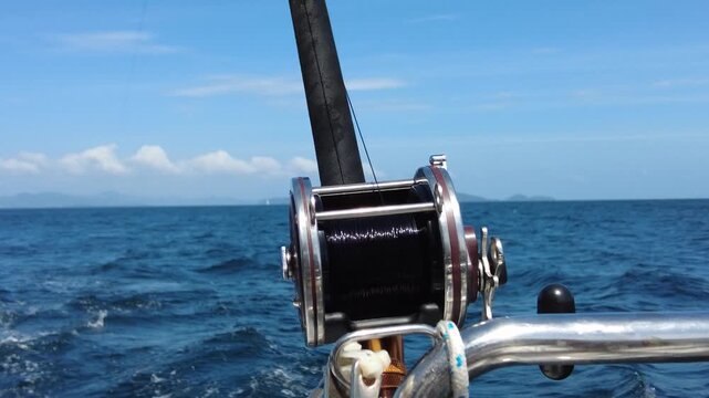 Trolling rod reel, fish caught on a hook, trolling fishing in the sea