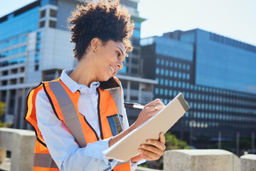Female Engineer Smiling and Taking Notes on Construction Site in City