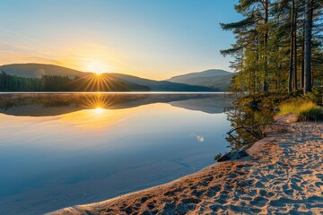 Obraz premium Sunrise over a serene lake with mountains in the background