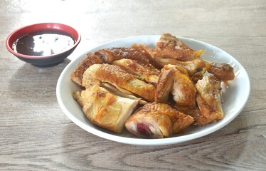 roasted chop chicken meat wing and leg on plate dipping with spicy sauce 