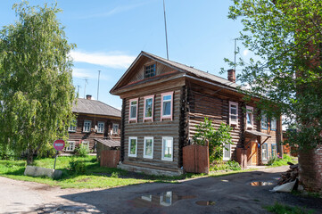 Typical traditional two-storey wooden house in Chukhloma town, Russia. Sunny summer day