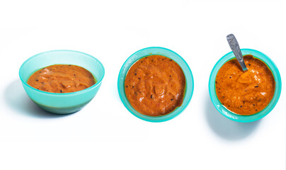 Hot and spicy onion chutney in a blue bowl on white background. Top view