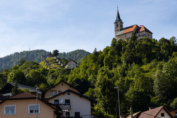 Fototapeta premium Velika Planina, Kamnik, Slovenia. Lord of the Rings style village. Wooden typical houses, hills, green meadows, flowers where cows and calfs graze. High quality artisanal milk and cheeses. Holiday.