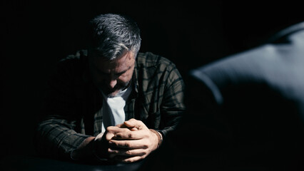 Distraught man in handcuffs keeping his head down, crime suspect, interrogation