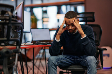 Exhausted African American Programmer Resting at Work.