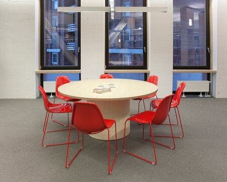 Modern meeting area in a building, college or office, round table and chairs.